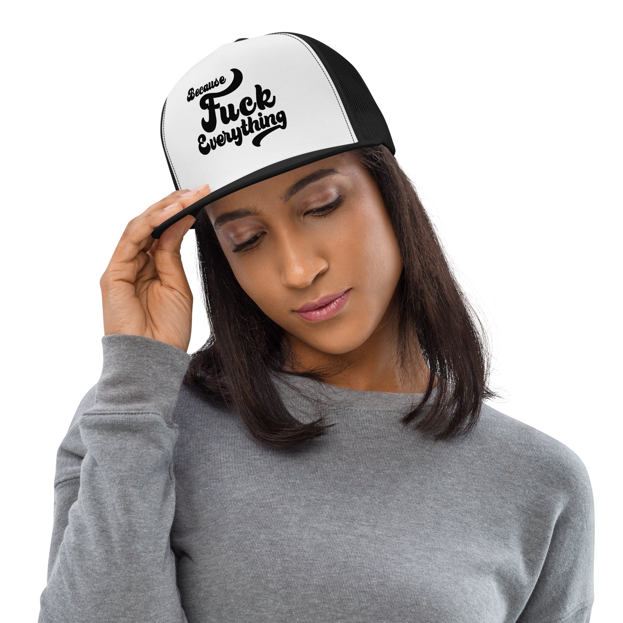woman wearing black mesh, white front trucker cap with the words Because Fuck Everything written on the front
