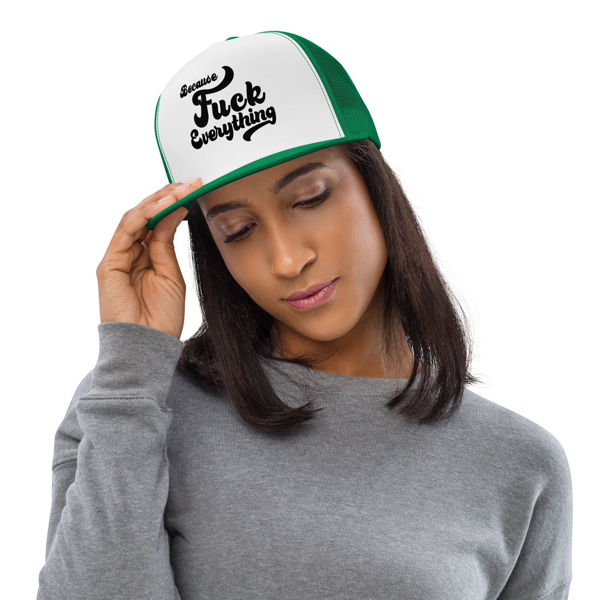 woman wearing green mesh, white front trucker cap with the words Because Fuck Everything written on the front