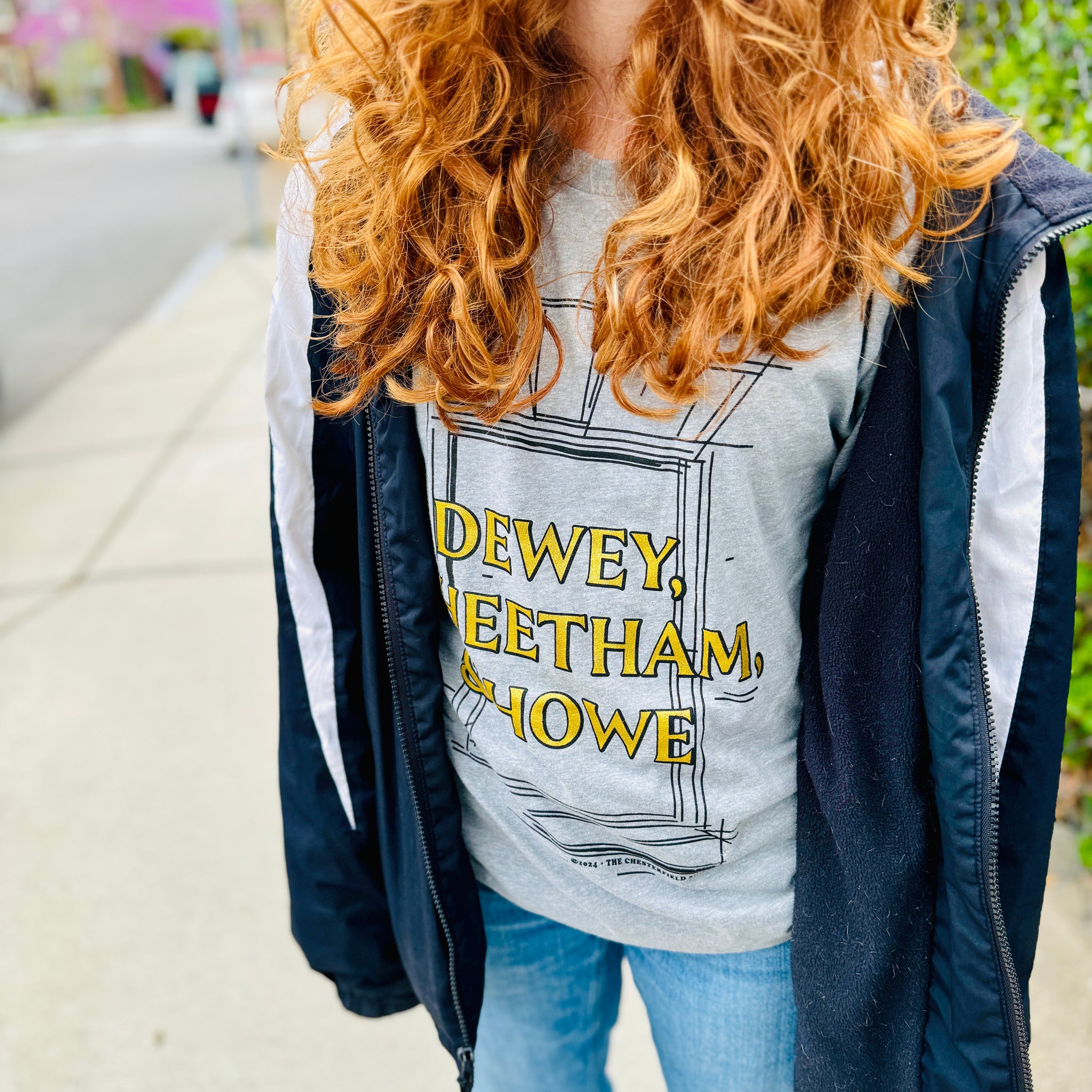 photo of woman wearing Light grey unisex t-shirt with Dewey Cheetham & Howe from Harvard square written on in gold