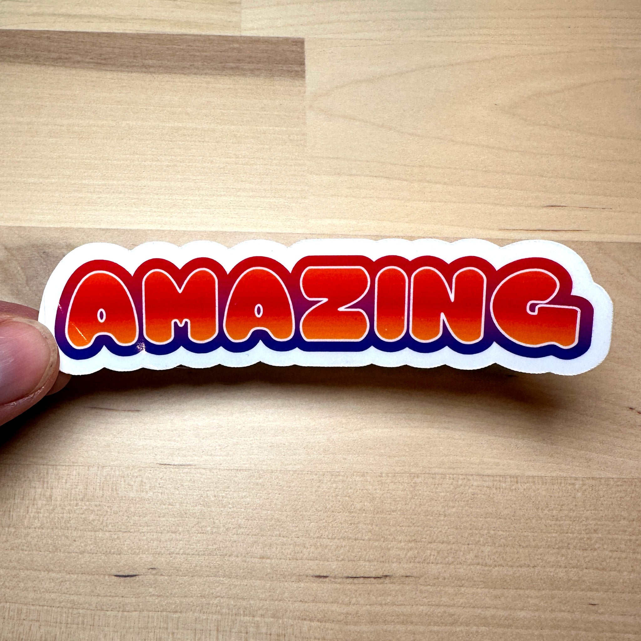 photo of vinyl sticker with the word amazing in orange blend with red and purple blend outline