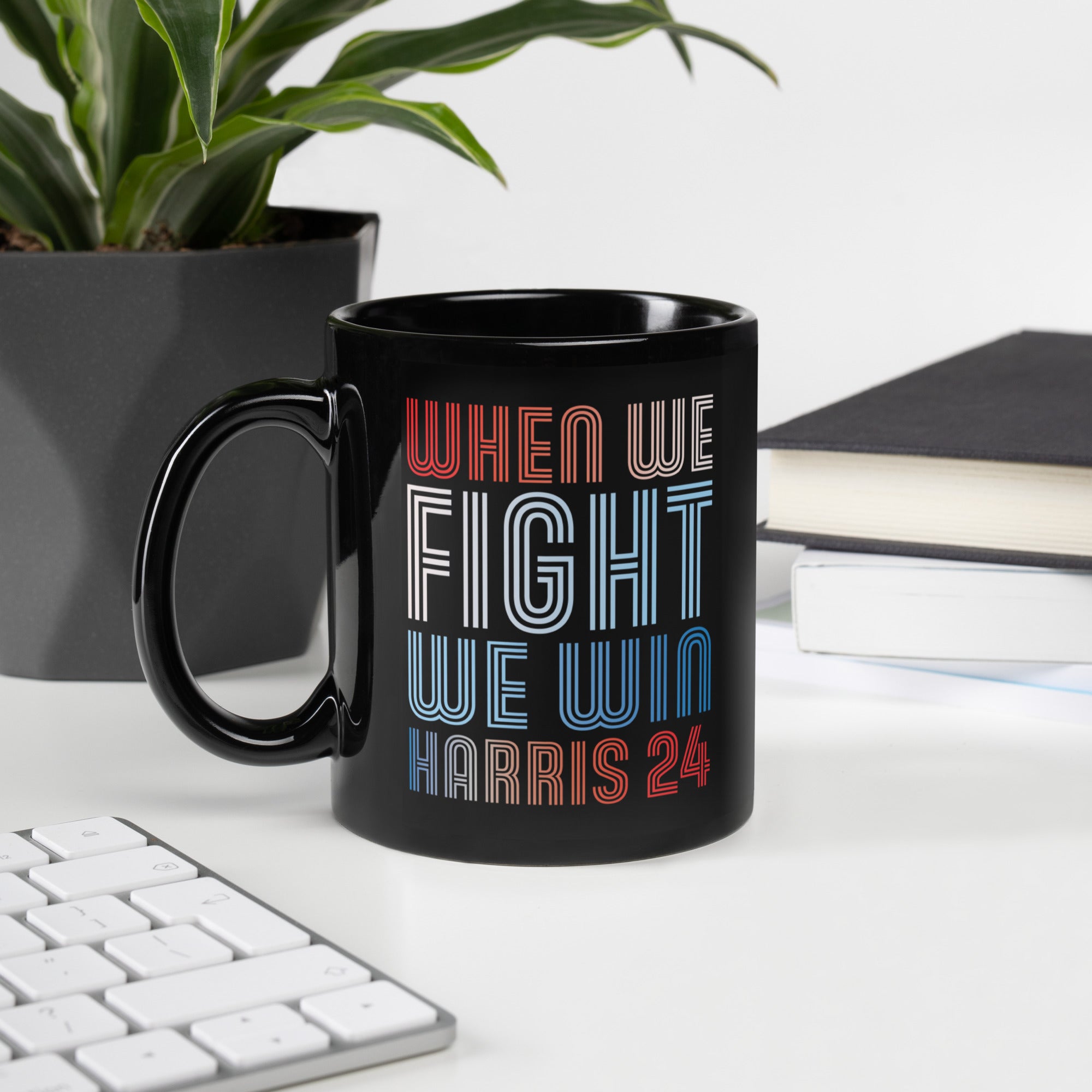 black ceramic mug with when we fight we win harris 24 in red white and blue blended text