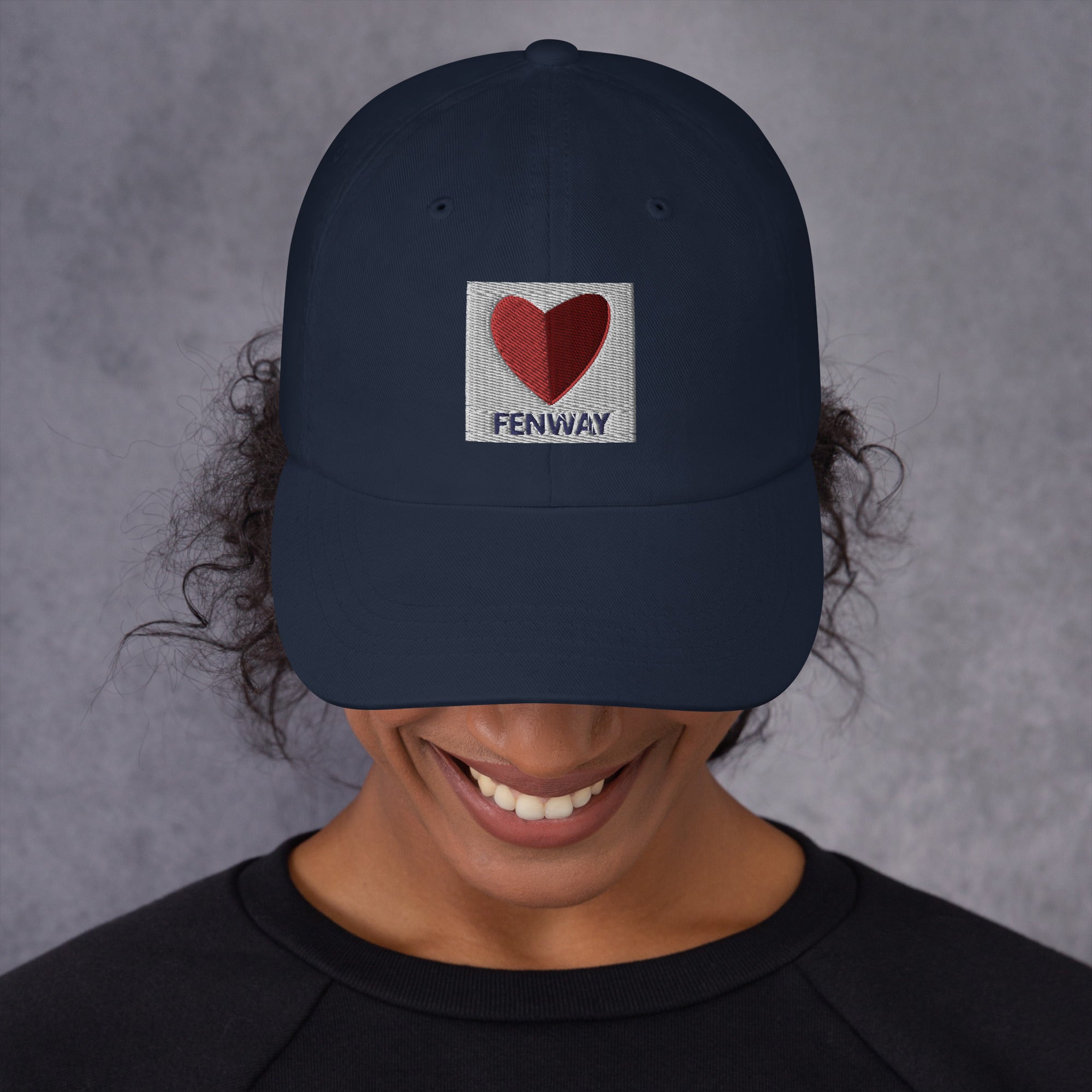 photo of woman wearing graphic of the citgo sign boston fenway as a heart embroidered on baseball hat