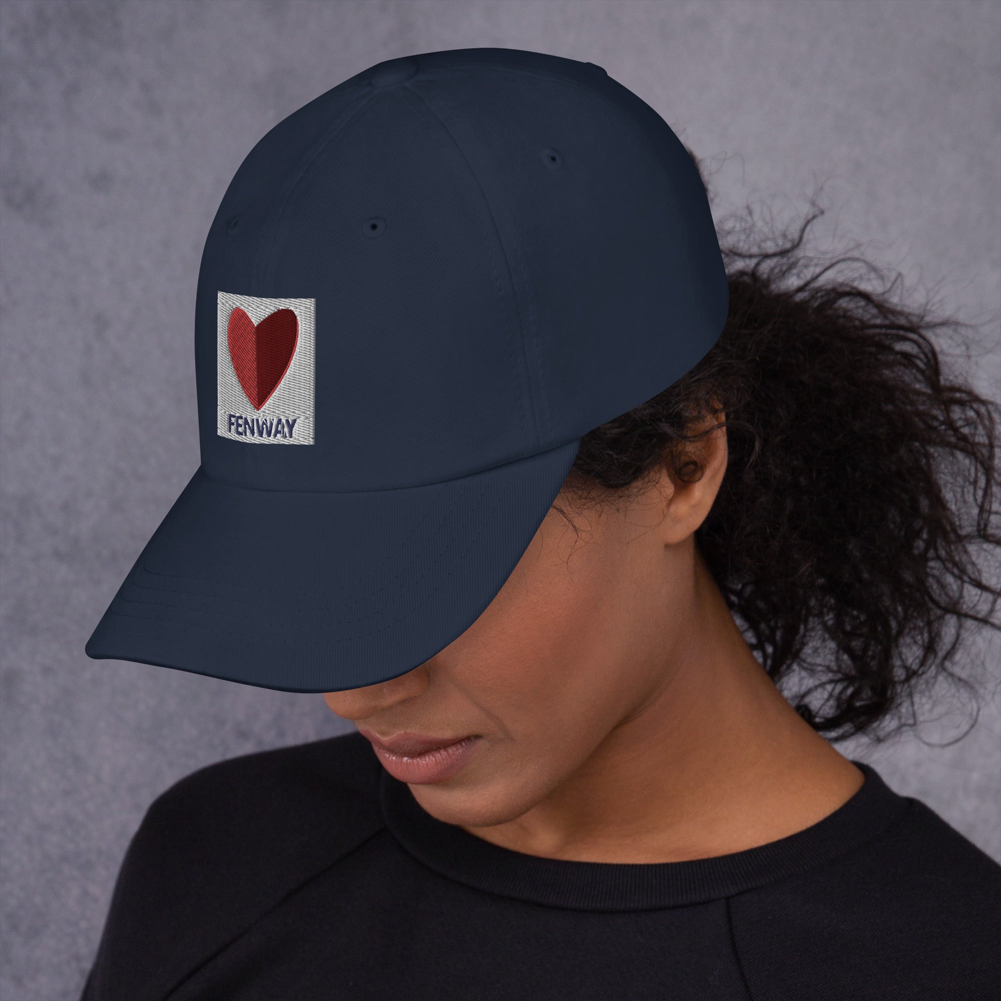 photo of woman wearing graphic of the citgo sign boston fenway as a heart embroidered on baseball hat