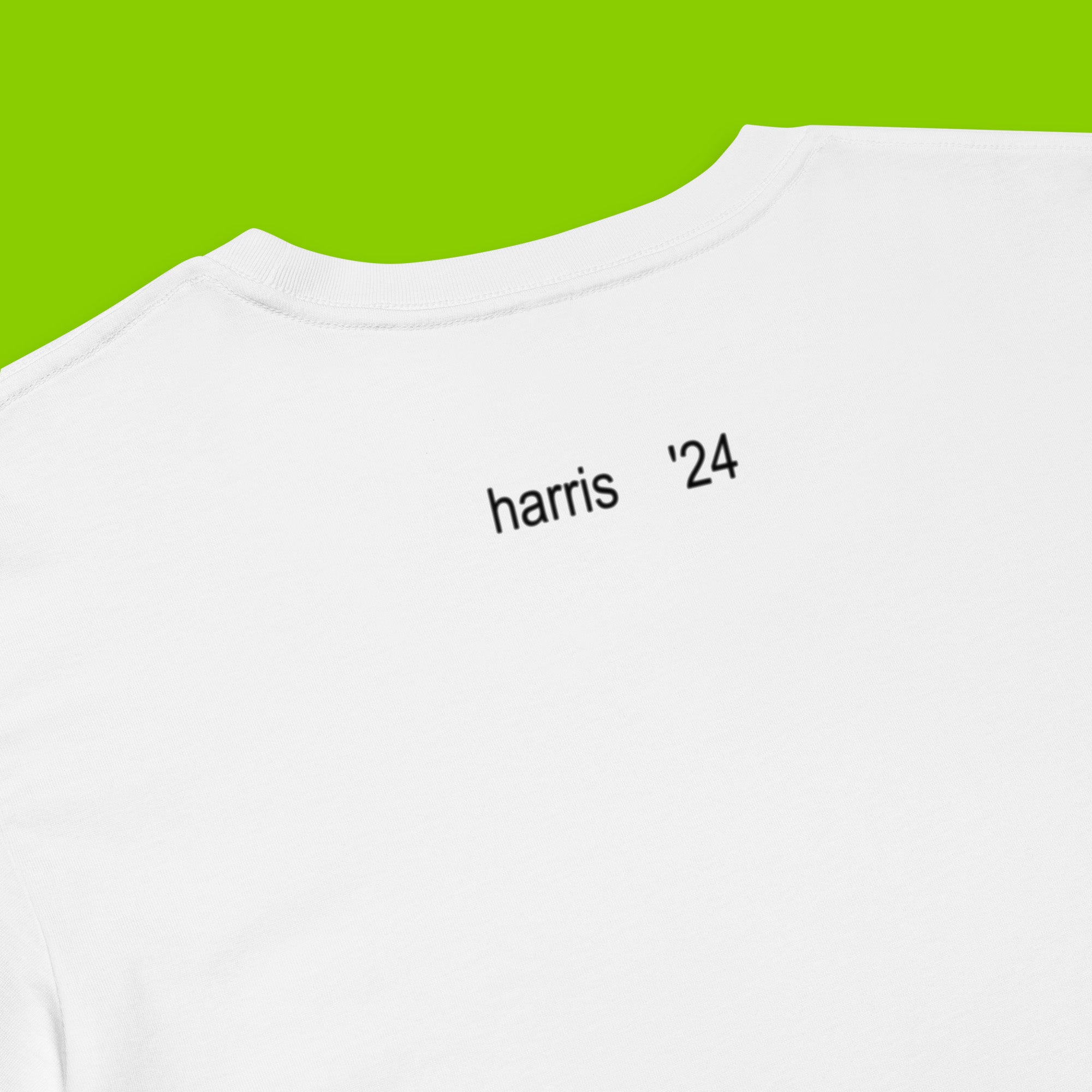 close up of back of white women's crop top t-shirt with the phrase harris 24 and charli xcx brat