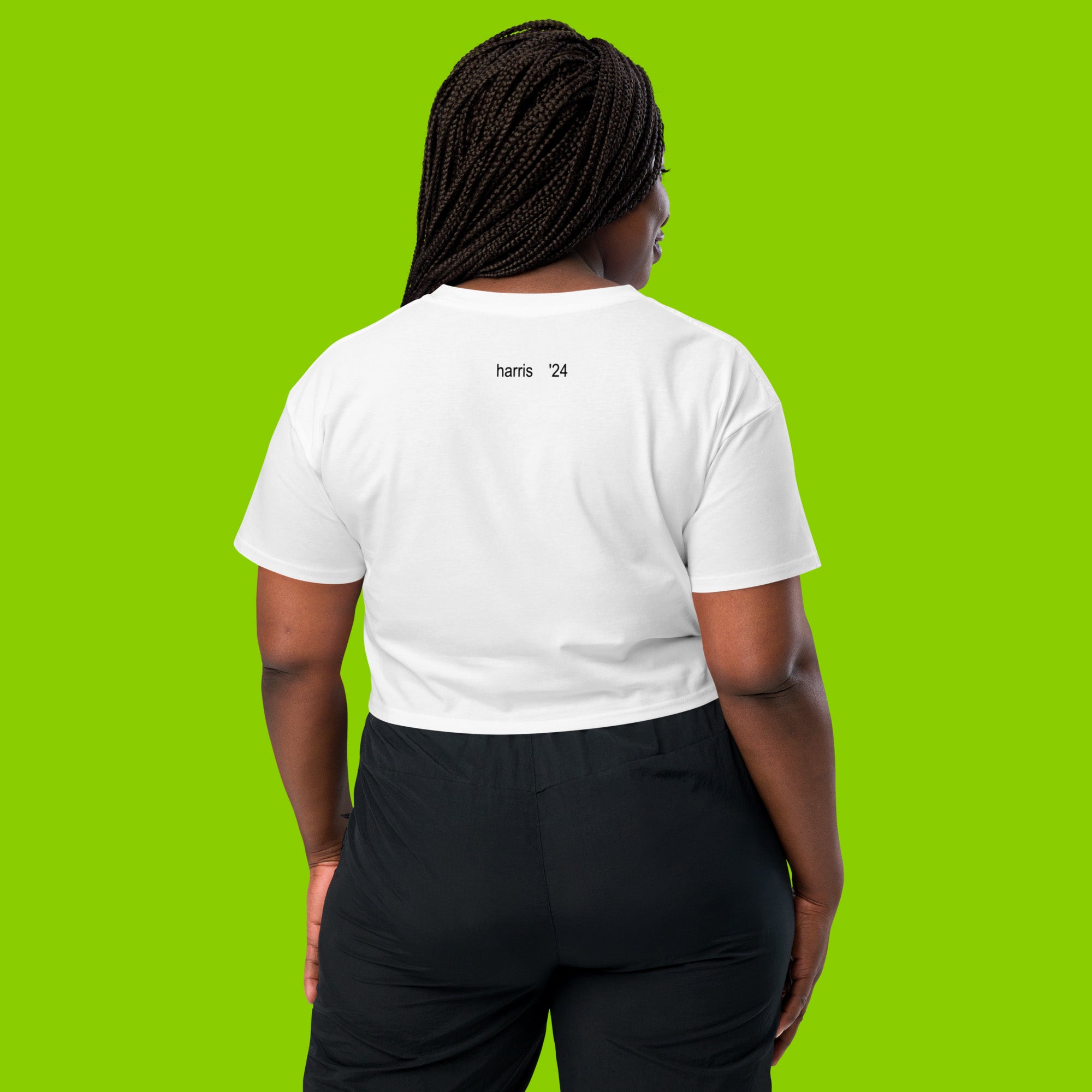 back of woman wearing white women's crop top t-shirt with the phrase harris 24 and charli xcx brat