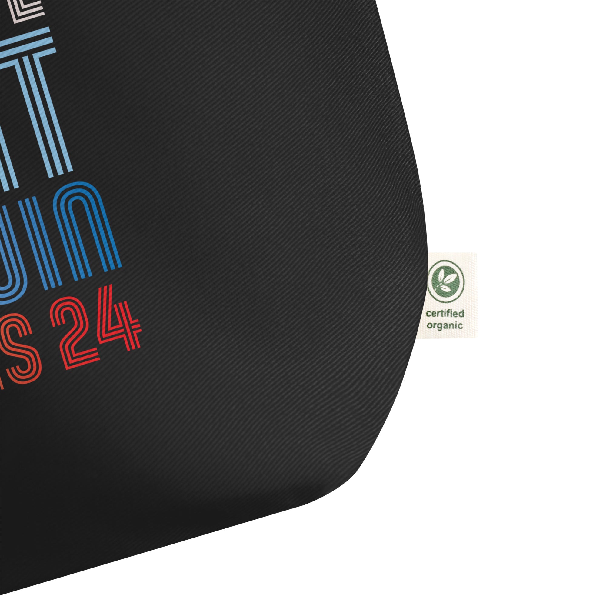 close up photo of black large tote bag with when we fight we win harris 24 in red white and blue blended text