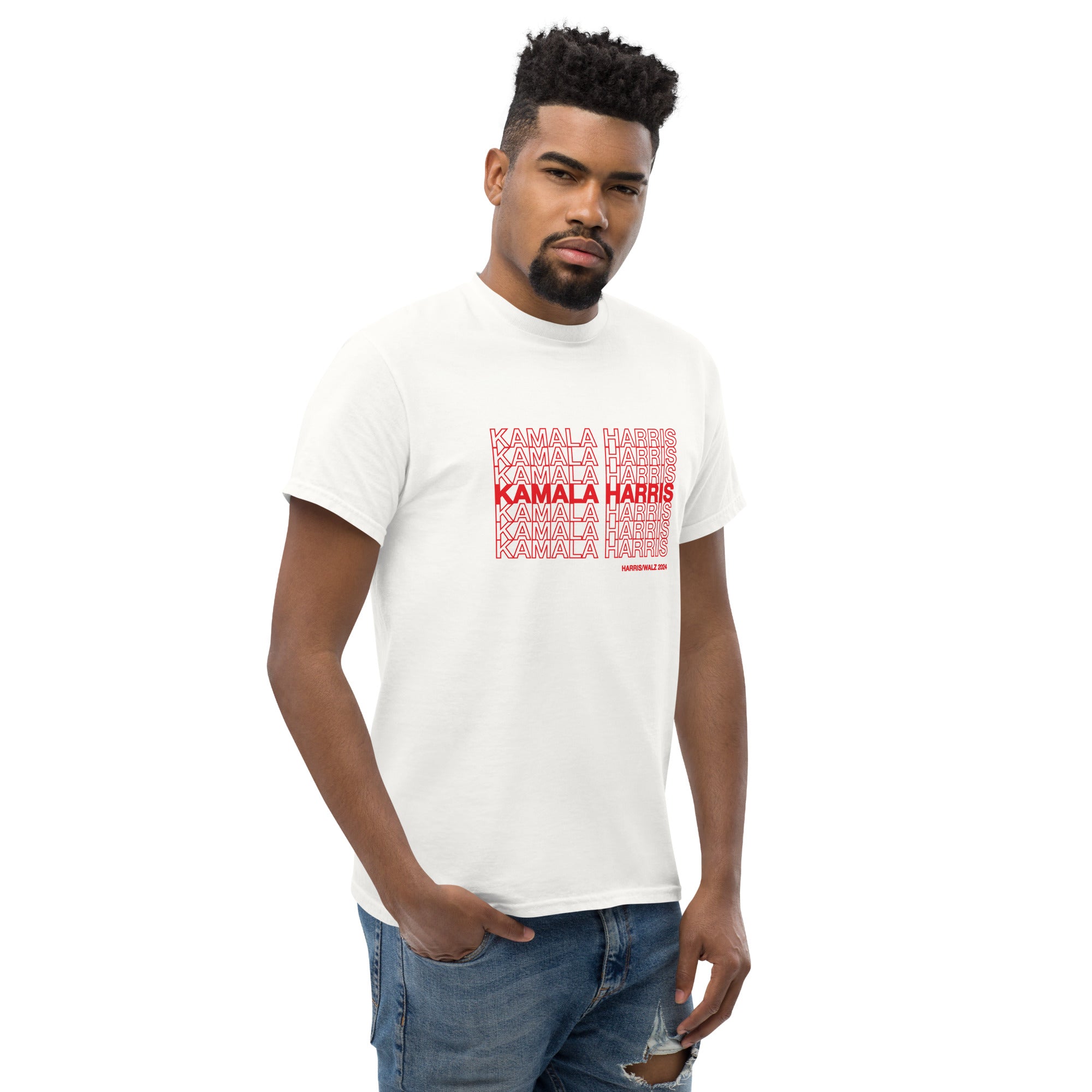 man wearing White unisex t-shirt with red text saying "kamala Harris" in the classic plastic shopping bag design