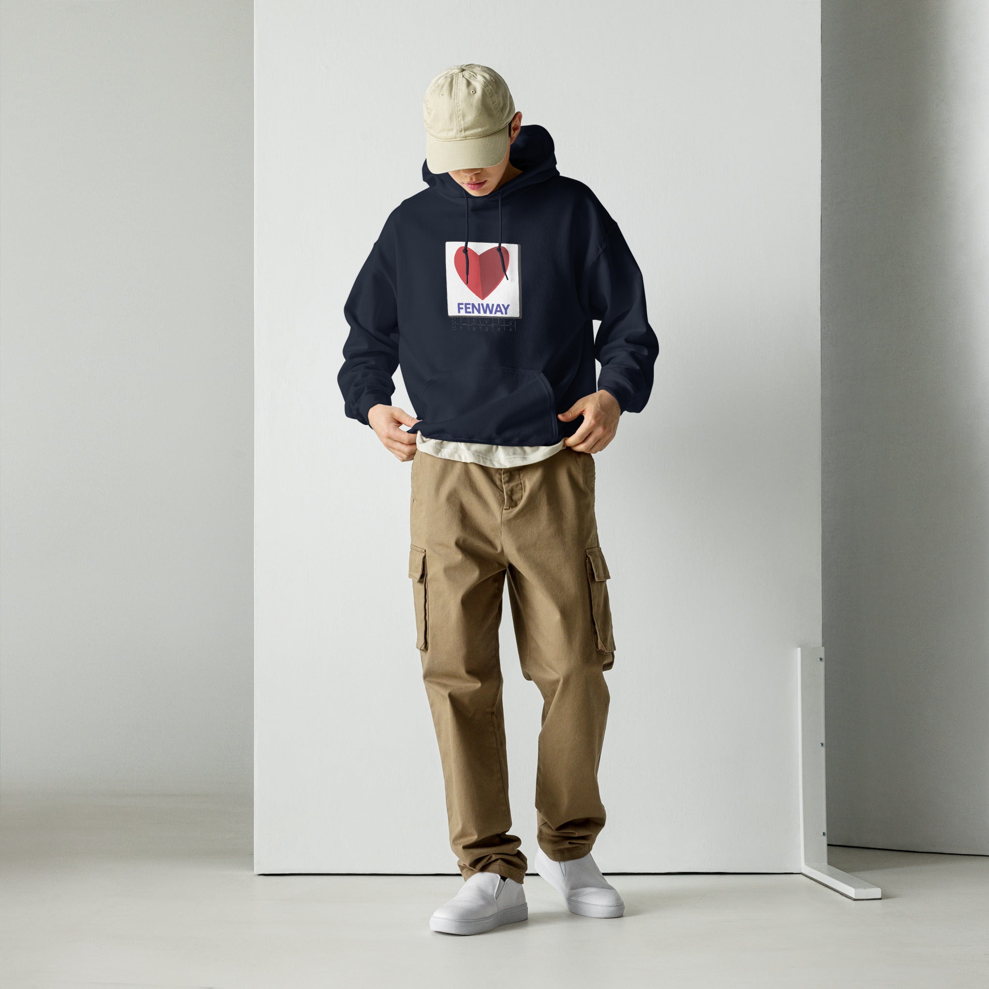man wearing unisex navy hoodie with graphic of the citgo sign boston fenway as a heart