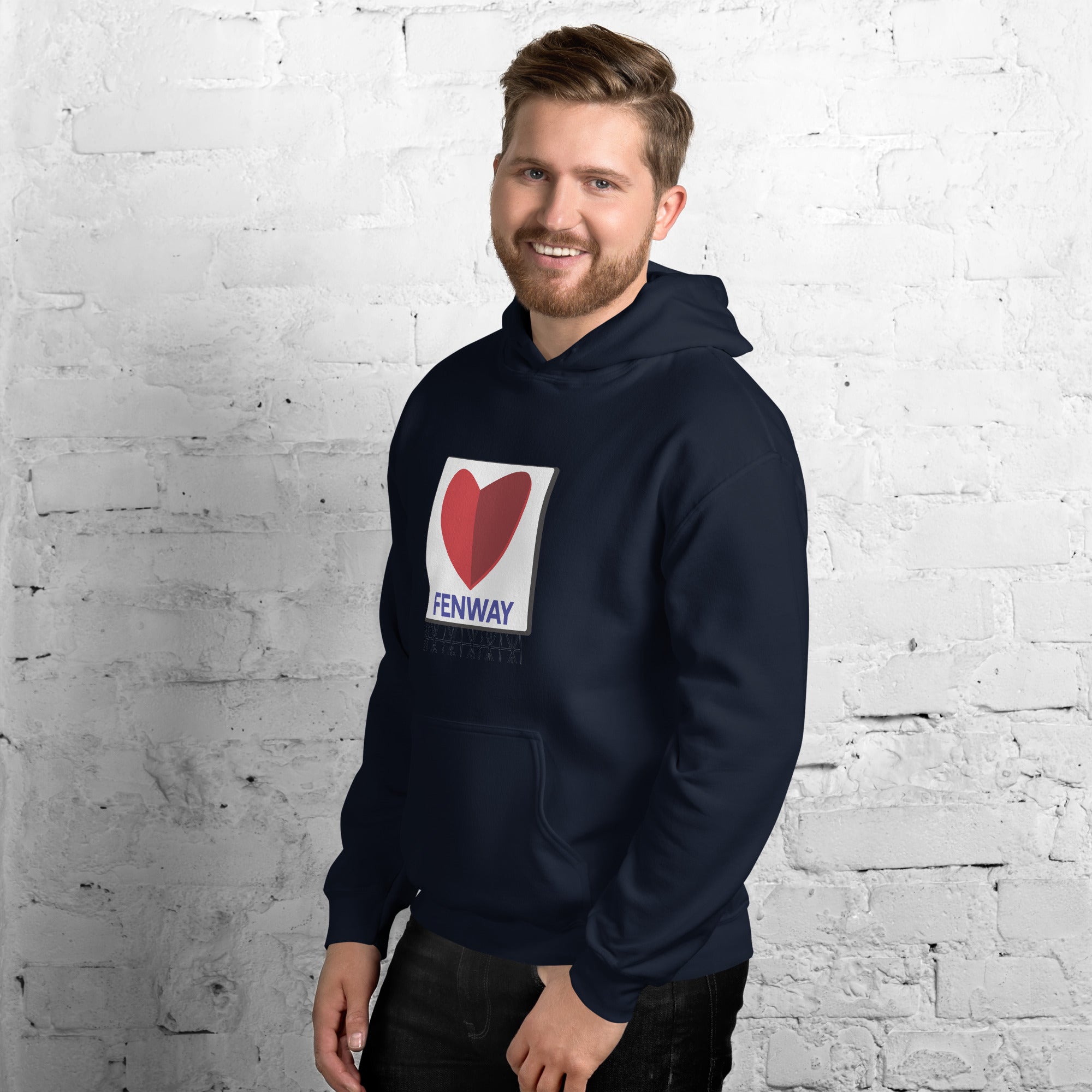 man wearing unisex navy hoodie with graphic of the citgo sign boston fenway as a heart
