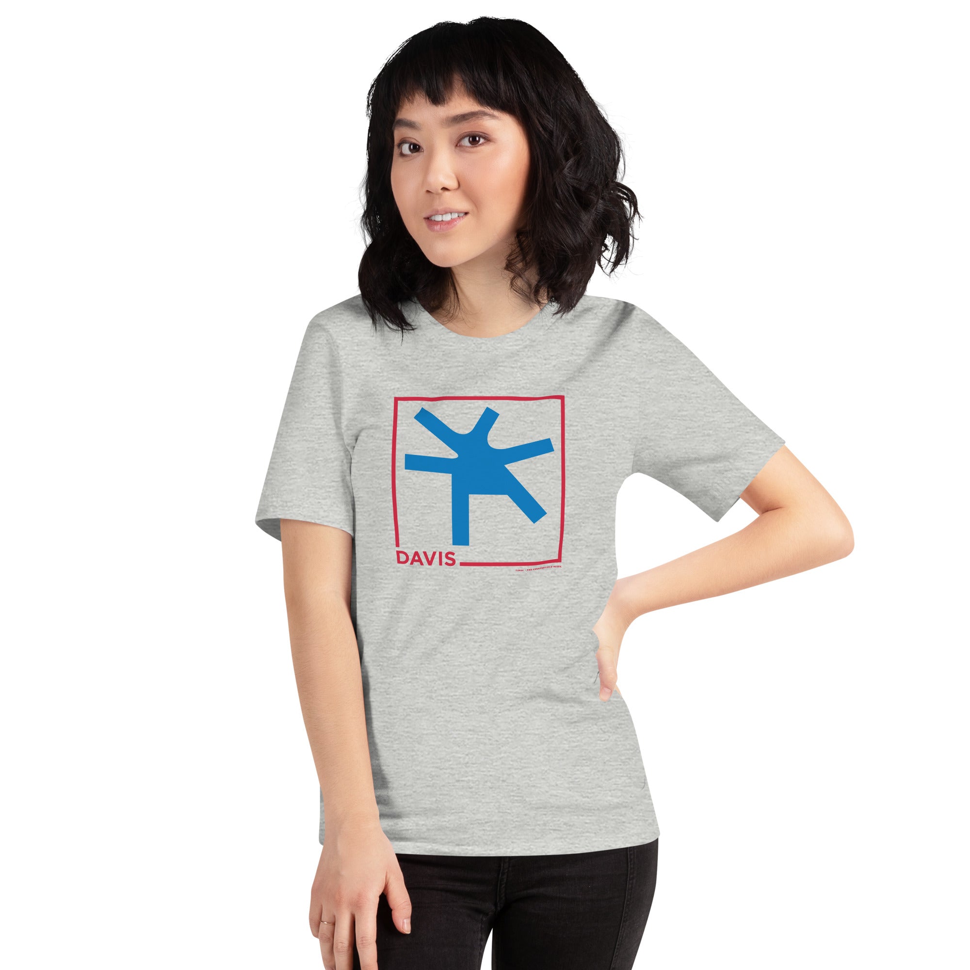 woman wearing Grey unisex t-shirt with the word Davis and a square in red, with the blue intersection