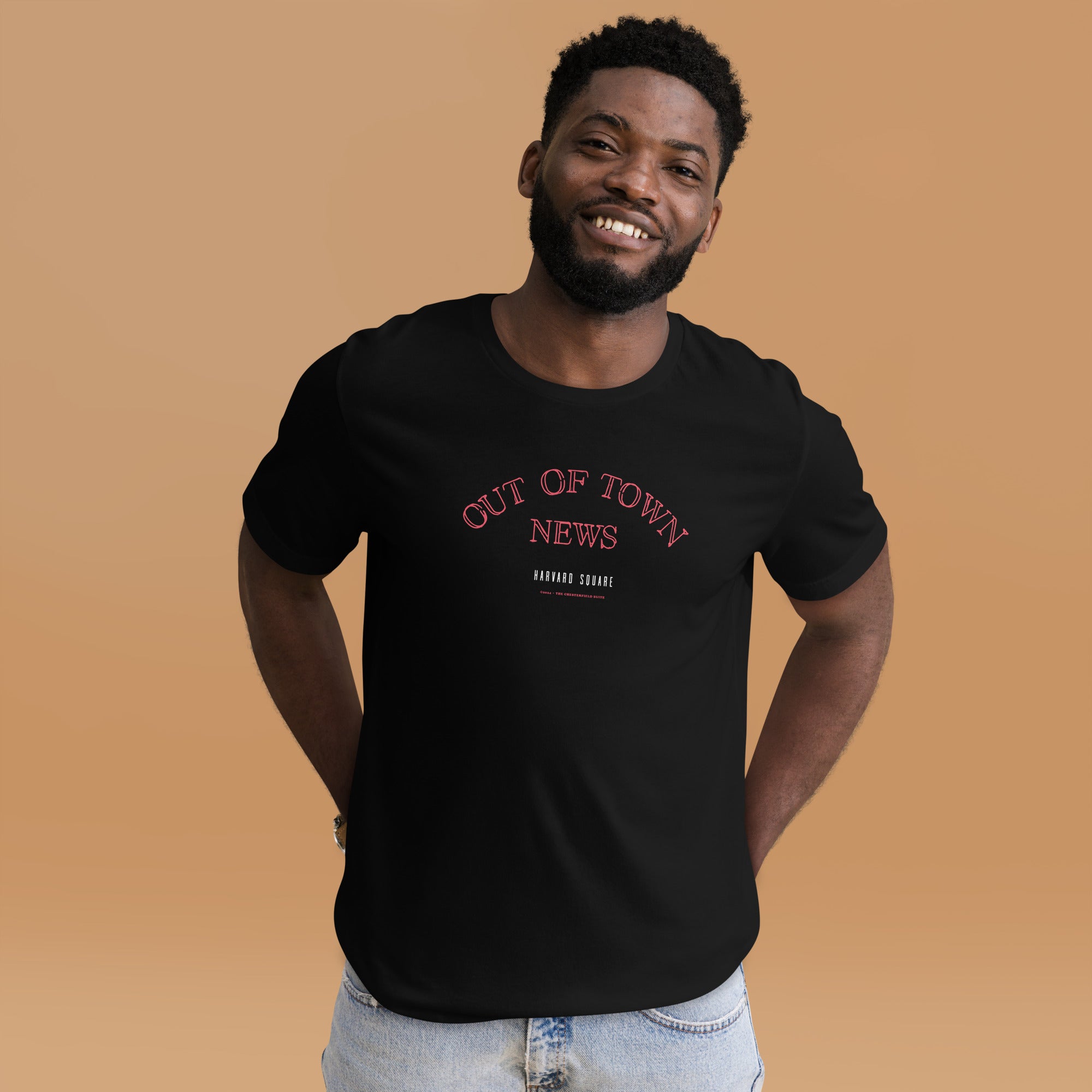 man wearing Black unisex t-shirt with Out of Town News Harvard Square written in red neon