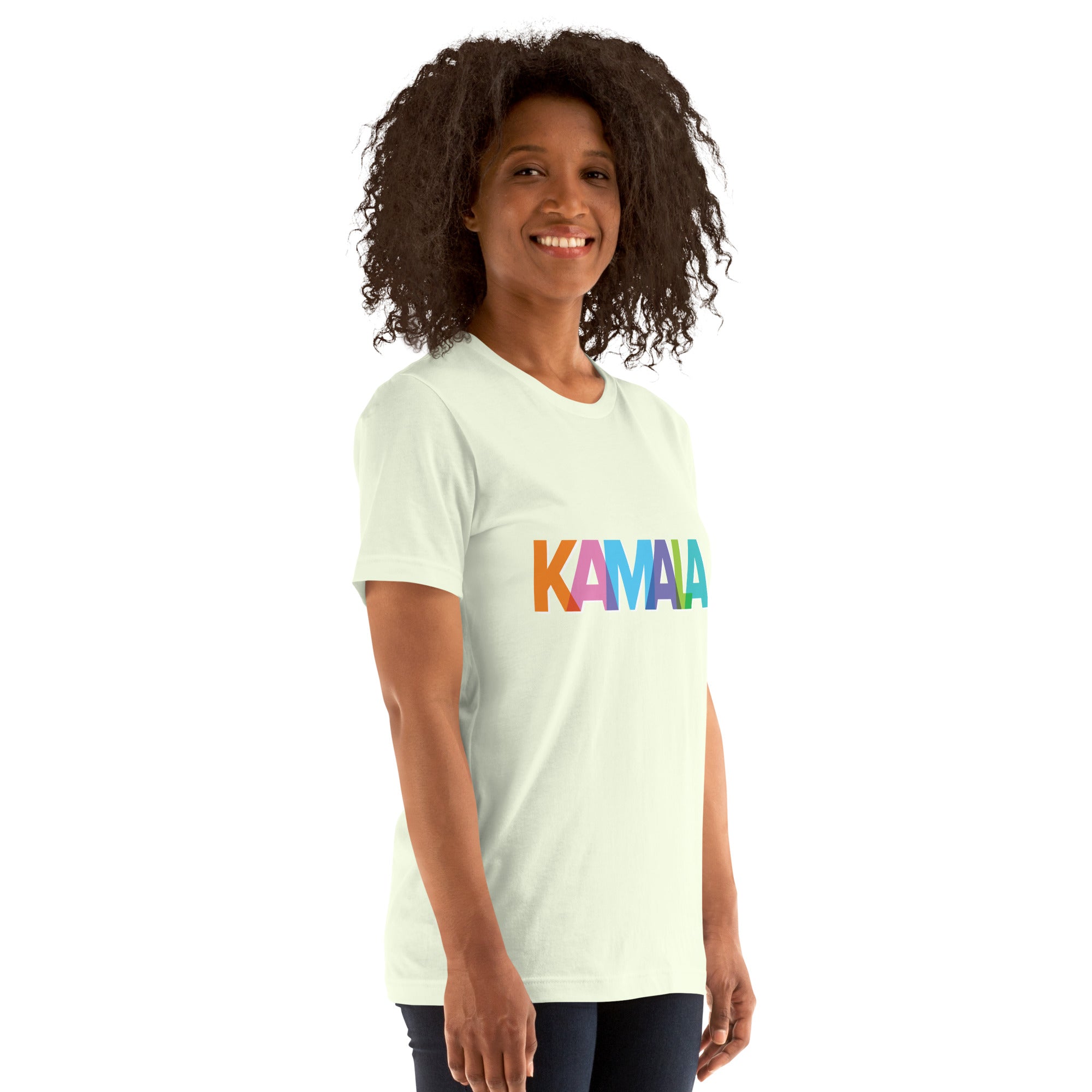 woman wearing citron colored unisex t-shirt with KAMALA on the front with multi colored overlapping letters