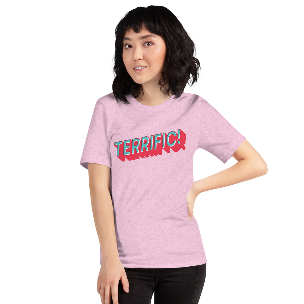 woman wearing Terrific! written in turquoise block lettering with red shadow on pink unisex tshirt