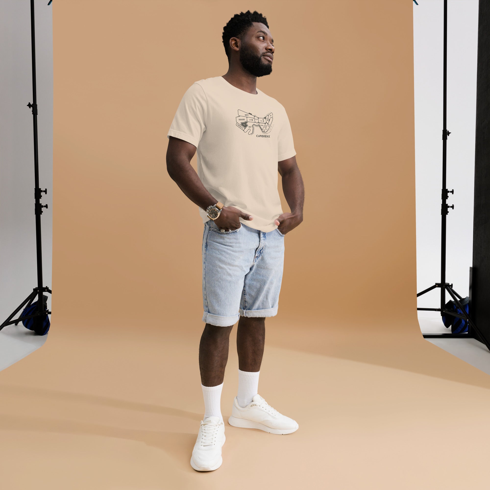 man wearing cream, tan unisex t-shirt with a hand drawn map of cambridge, ma in dark grey