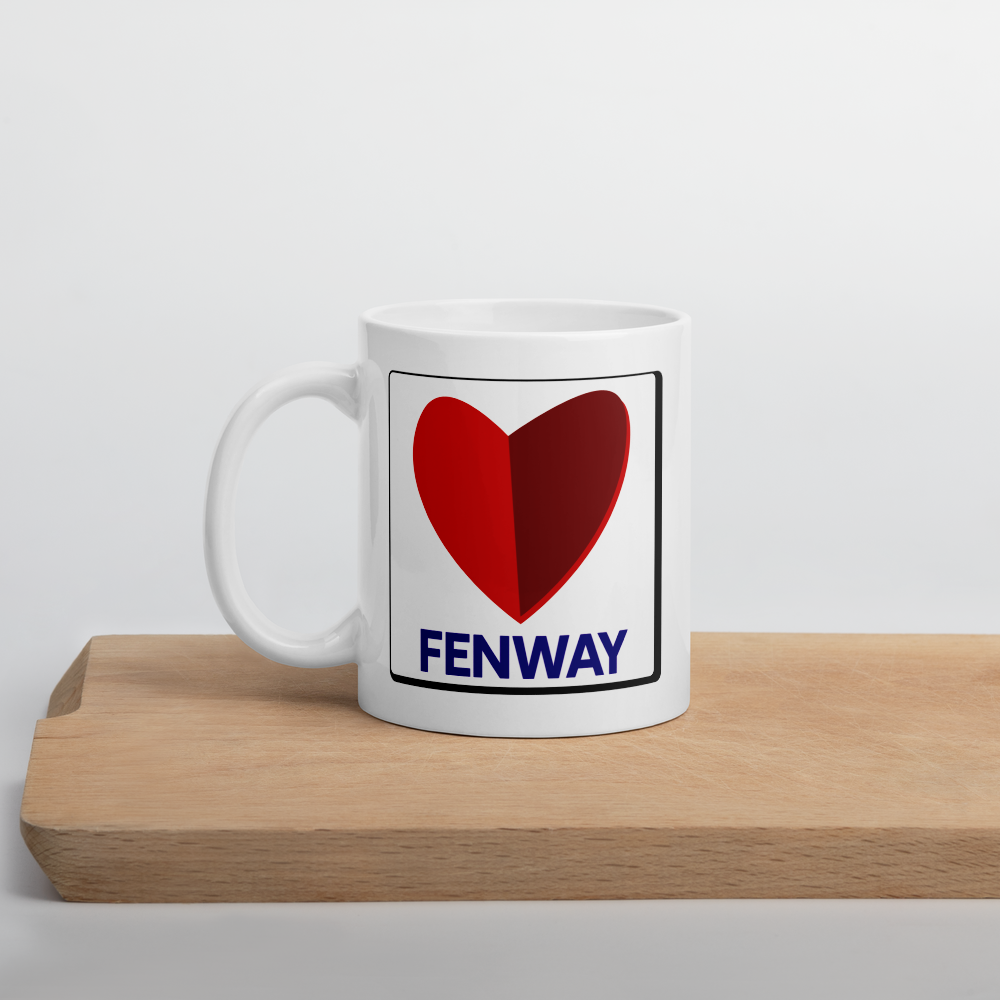 white ceramic mug on a cutting board with the word fenway and the citgo sign as a heart