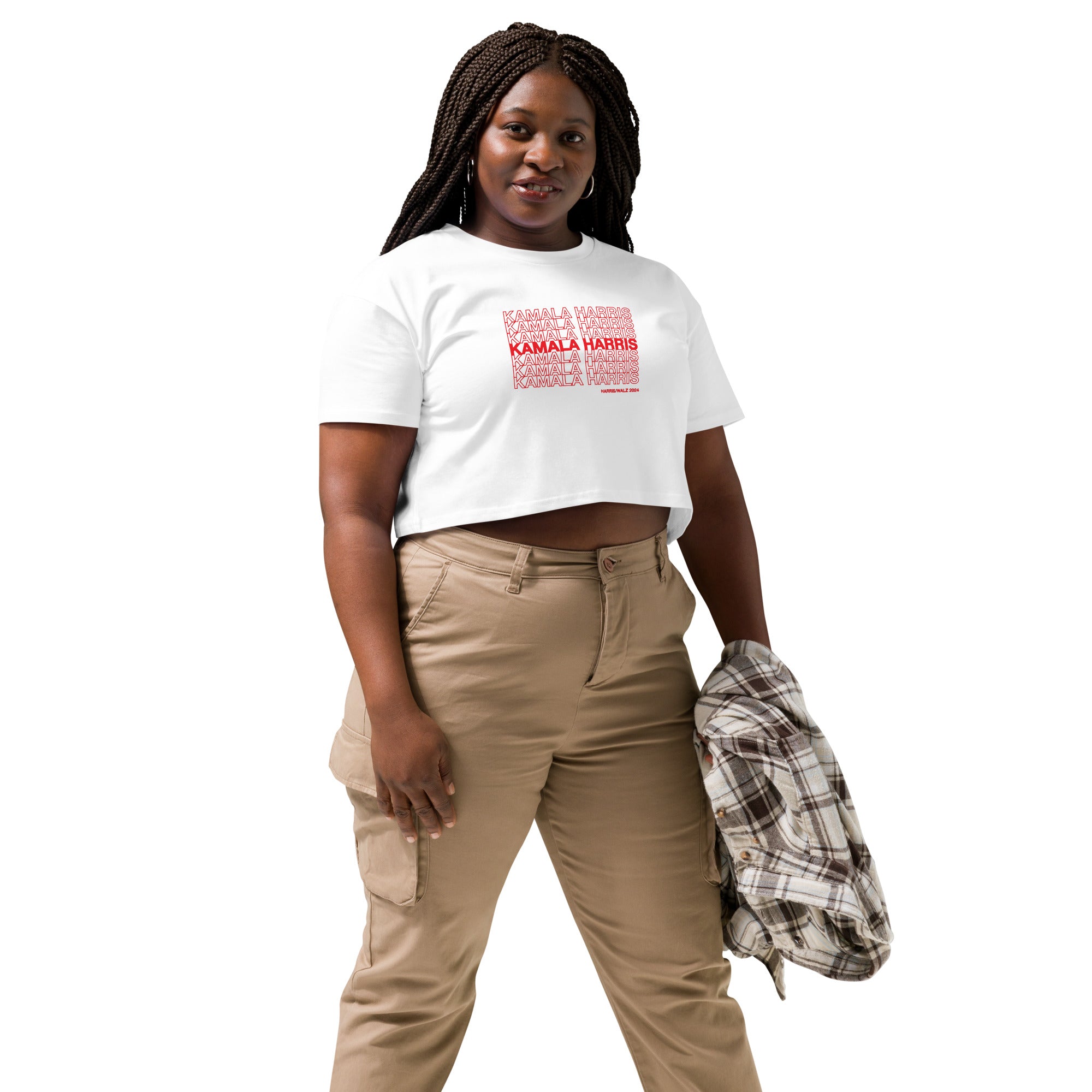 woman wearing White women's crop top t-shirt with red text saying "kamala Harris" in the classic plastic shopping bag design