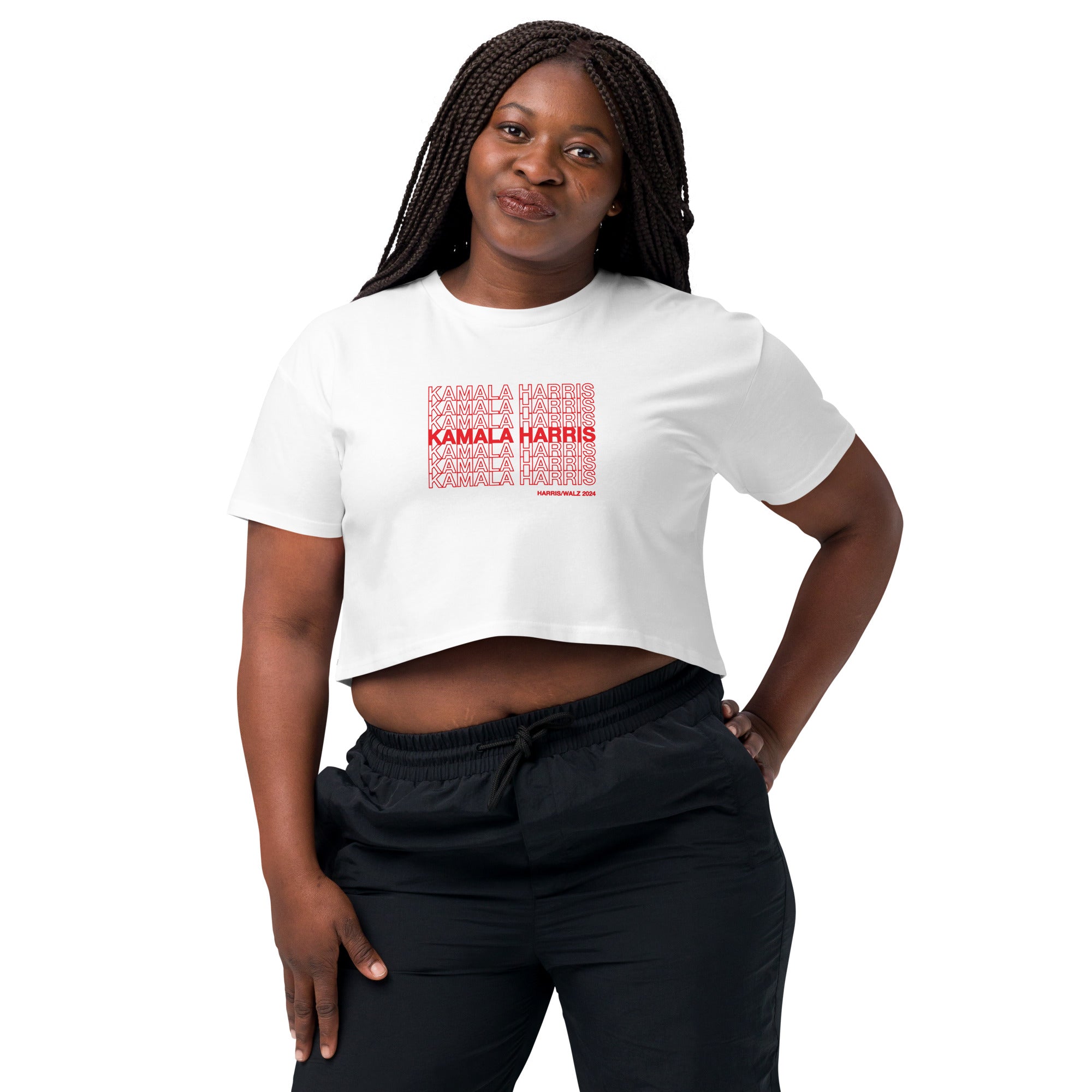 woman wearing White women's crop top t-shirt with red text saying "kamala Harris" in the classic plastic shopping bag design