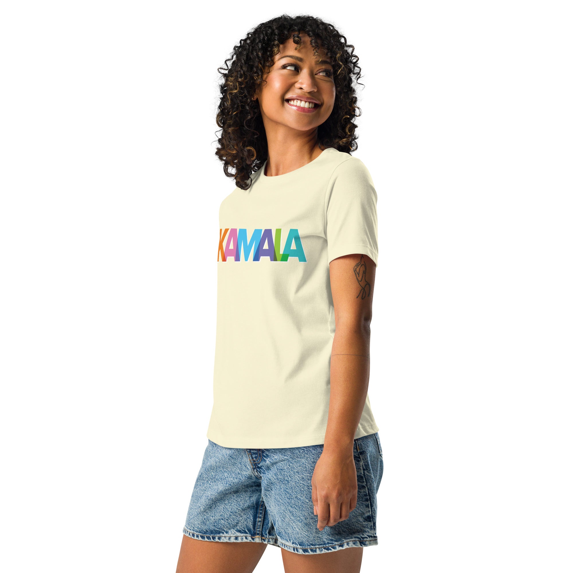 woman wearing citron colored women's t-shirt with KAMALA on the front with multi colored overlapping letters