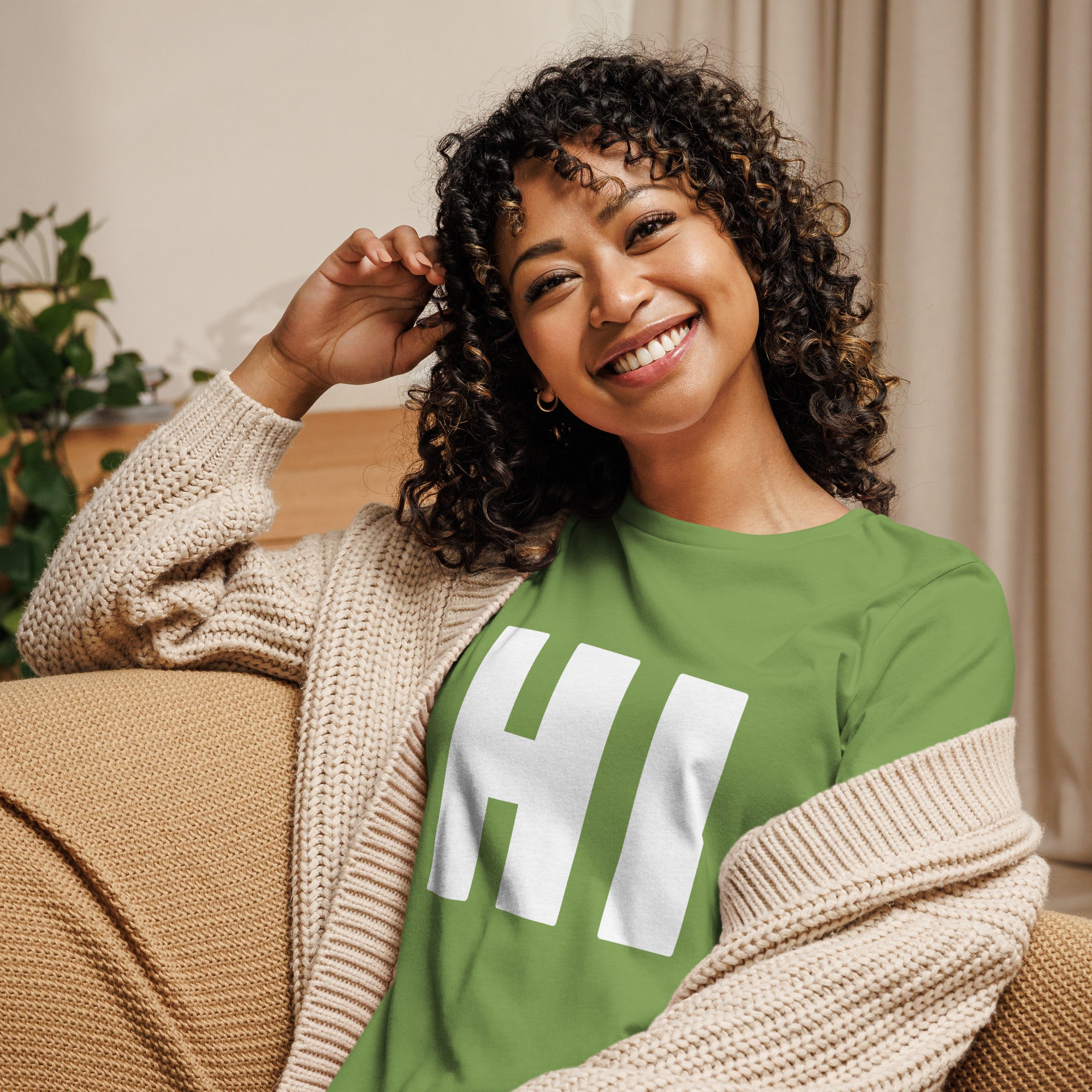 photo of a woman wearing the word HI in white on a green women's t-shirt
