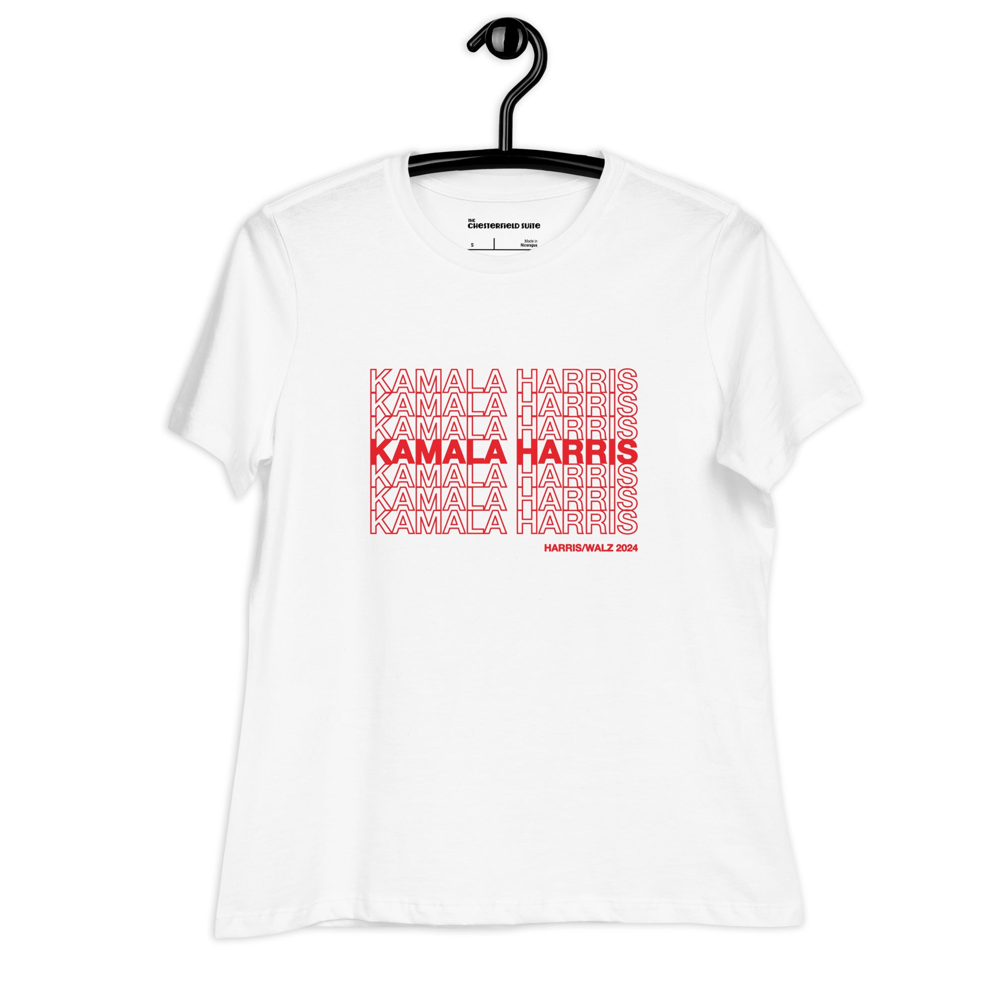 White women's t-shirt with red text saying "kamala Harris" in the classic plastic shopping bag design on a black hanger